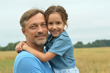 Fototapeta premium Dad with daughter in field