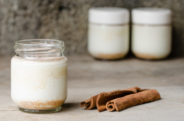 Cinnamon yogurt, rustic background.