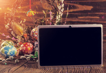 Easter background. the composition colored Easter eggs with flowers and blooming willow on the wood background