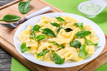 italian ravioli with creamy spinach sauce, close-up