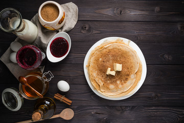 ingredients for baking pancakes on a wooden background