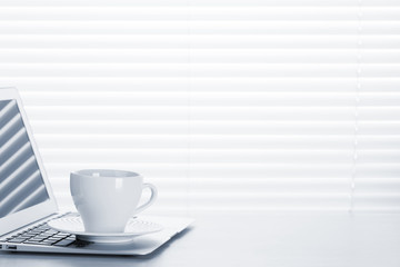 Office workplace with with laptop and coffee cup