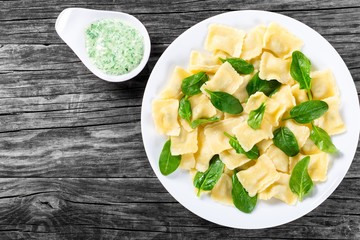 italian ravioli with creamy spinach sauce, top view