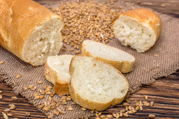 Bread with grains of wheat on burlap