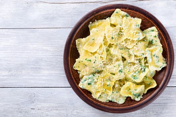 Italian ravioli smothered in creamy spinach sauce, top view