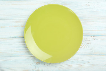 Green plate on a blue wooden table