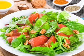Red fish salad with mixed lettuce leaves