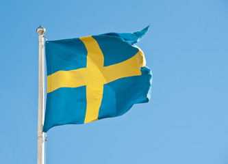Flag of Sweden against blue sky
