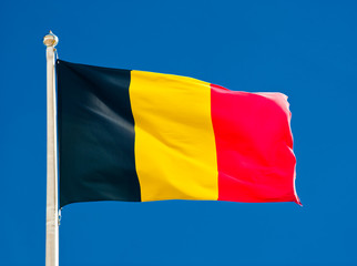 Flag of Belgium  against blue sky
