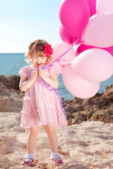 Fototapeta premium Kid girl 4-5 year old celebrating birthday. Holding balloons. Childhood. 
