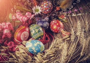 Easter decoration. colored Easter eggs and composition of dried flowers and wheat