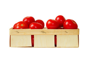 Ripe tomatoes in a basket isolated on white
