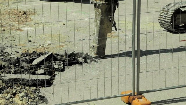 Asphalt Demolishing With Jackhammer Tool at Construction Site