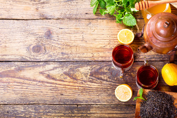 Teapot and cup of tea with mint and lemon