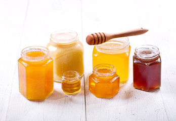 various types of honey in glass jars