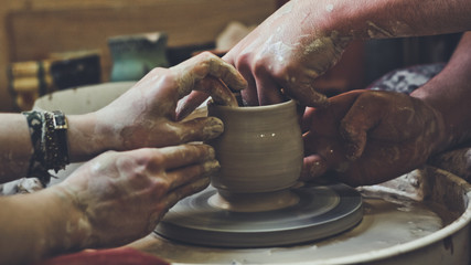 working with a potter's wheel. two pairs of arms