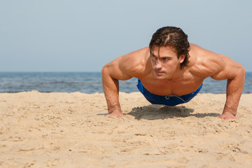 Fototapeta na wymiar Man during workout on the beach