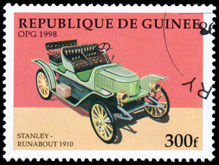 Fototapeta na wymiar Stamp printed in Guinea shows vintage car Stanley-Runabout