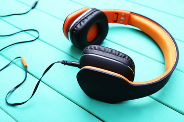 Headphones on wooden background