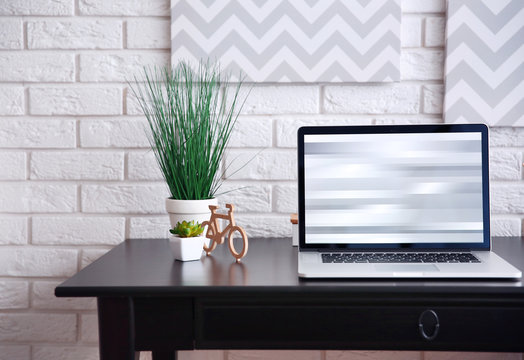 Workplace with laptop on table at home