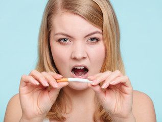 Girl breaking up with cigarette.