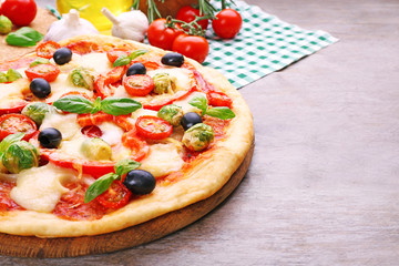 Delicious pizza with cheese and vegetables on wooden table closeup