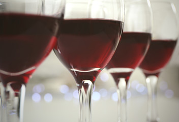 Glasses of red wine on white table closeup