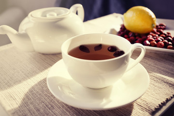 Rose hip and lemon tea on table in the room