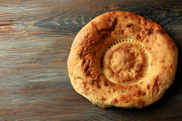 Fresh fried bread on wooden background