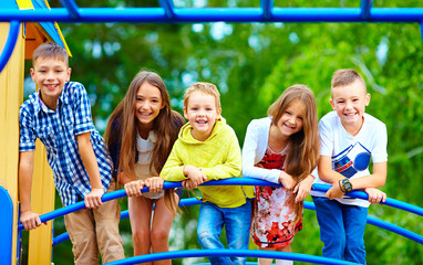 smiling excited kids having fun together on playground © Olesia Bilkei
