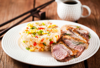 Fried duck  and rice with vegetables and eggs