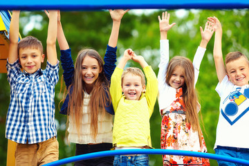 happy excited kids having fun together on playground © Olesia Bilkei