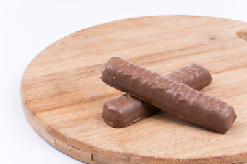 Two chocolates on a wooden board