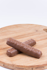 Two chocolates on a wooden board