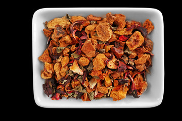Herbal mix tea in bowl, isolated on white