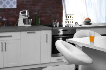 Modern kitchen interior with white furniture and electric stove