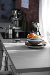 Modern kitchen table with electric stove beside the window