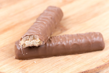 Two chocolates with a stuffing on a wooden board