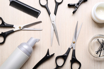 Barber set with tools and cosmetic on light wooden table