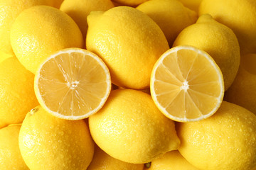 Pile of wet lemons with halves closeup