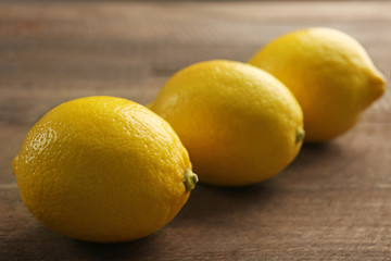 Fresh lemons on wooden background