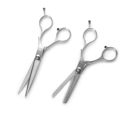 Two professional metal scissors in open positions isolated on white background