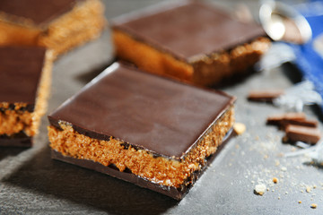 Tasty homemade cakes with chocolate on dark background, close up