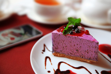 Tasty cheesecake on table in cafe or restaurant
