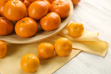 Delicious tangerines and small mandarins  on the white wooden table, close up