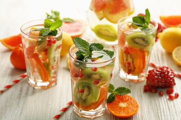 Refreshing cocktails with ice, mint, pomegranate seeds and slices of fruits