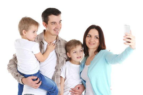 Happy family making selfie with mobile phone isolated on white