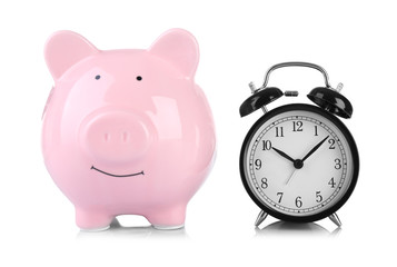 Pink piggy bank and clock isolated on white