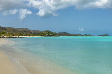 Tropical beach at Antigua island in Caribbean with white sand, t