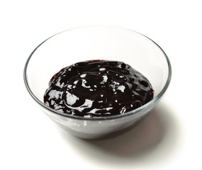 Sweet blueberry berries jam in the transparent glass bowl